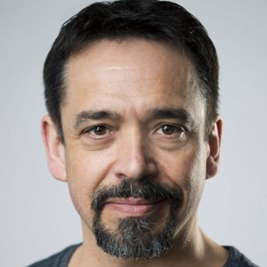 Headshot of a man with short hair and a goatee